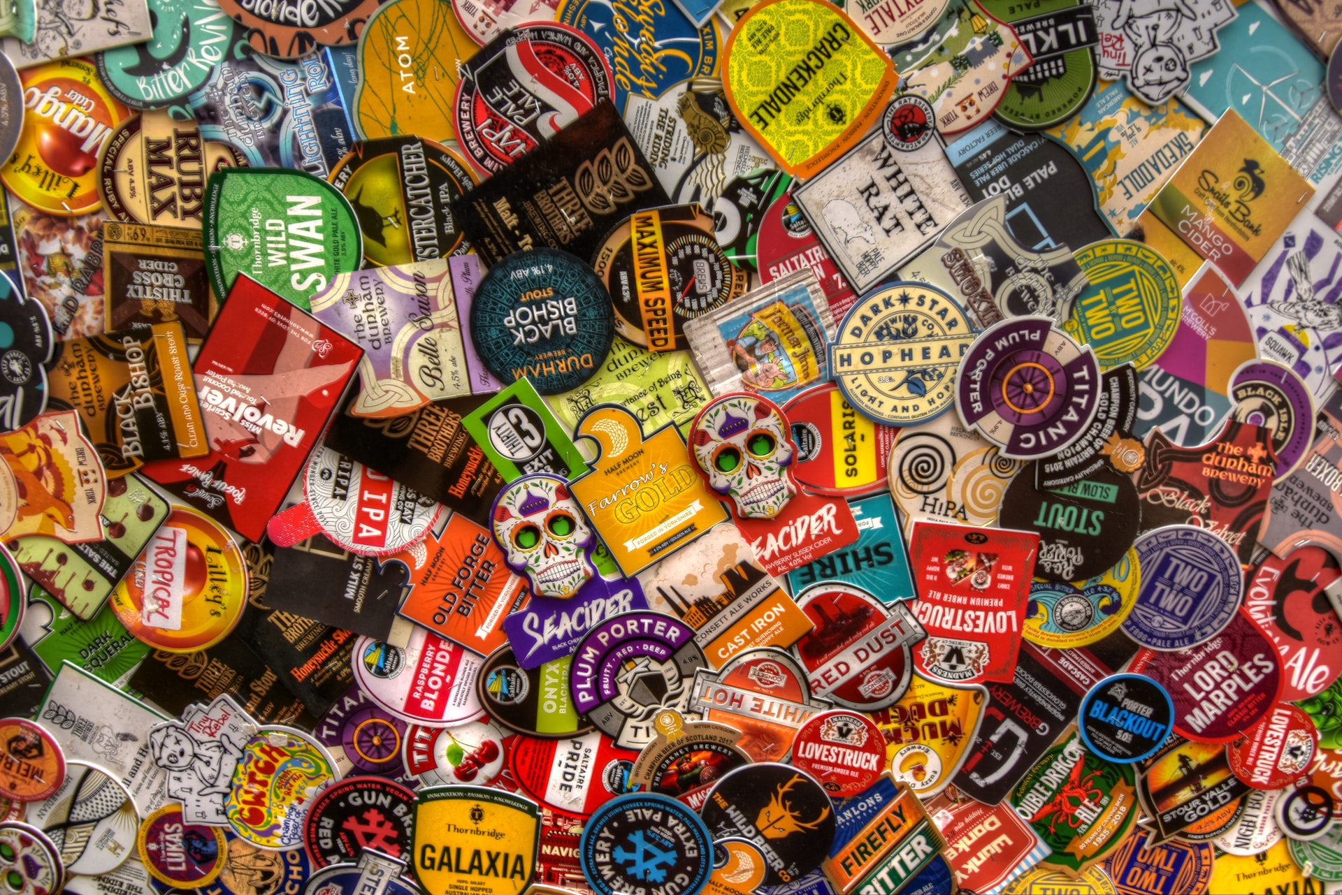 A pile of stickers with various brand logos